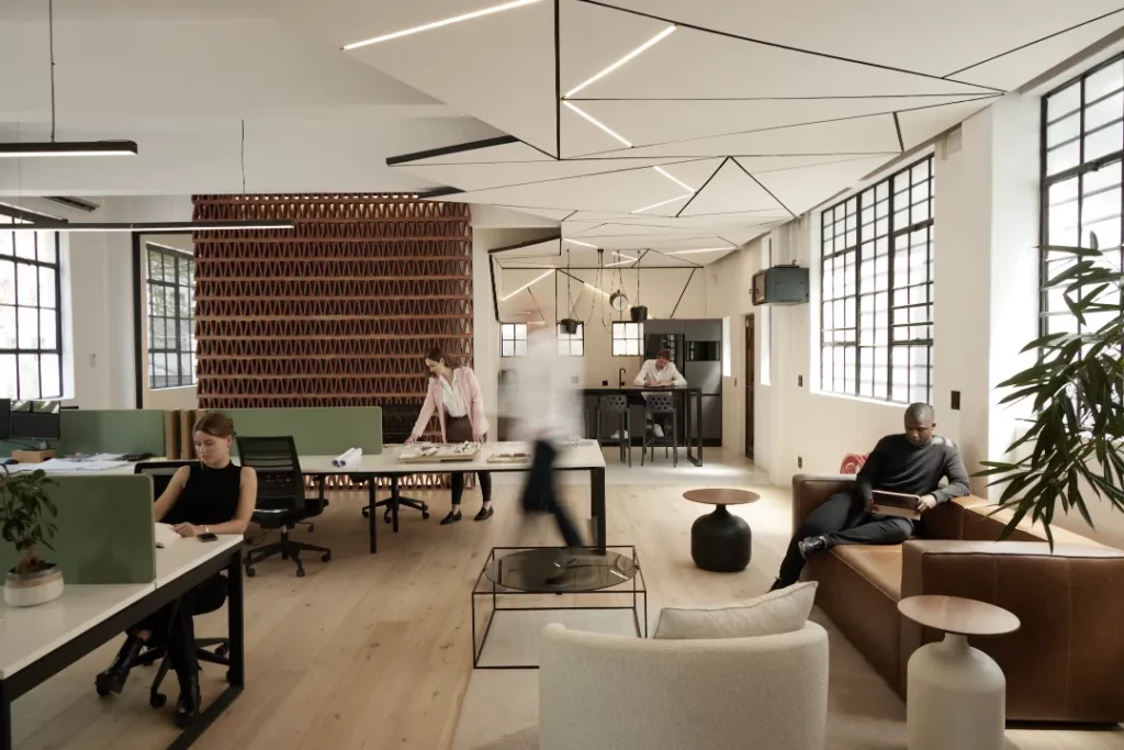 The TERRĀ studio team at work in their Cape Town interior design studio, reviewing material samples